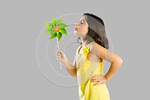 Girl blowing a windmill