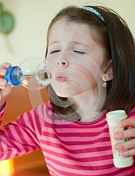 Girl blows bubbles