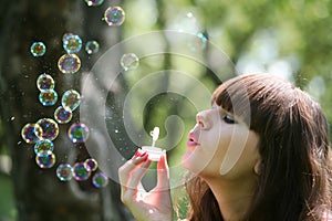 Girl blows soap bubbles