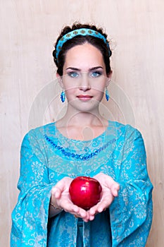 Girl in a blue dress with Apple in the Palm of your hands