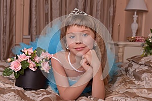 Girl in blue dress resting on a sofa