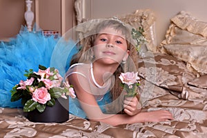 Girl in blue dress resting on a sofa