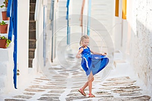 Girl in blue dresses having fun outdoors on Mykonos streets