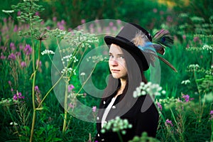 A girl with blue eyes in a top hat