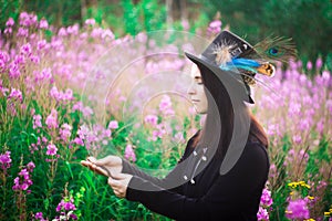 A girl with blue eyes in a top hat