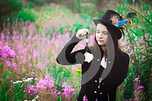 A girl with blue eyes in a top hat