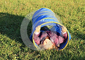 Girl in blue kids tunnel