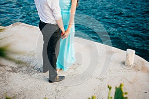 A girl in a blue sarafan and a guy in trousers and a shirt on th