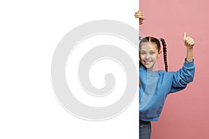 Girl in blue sweater giving thumbs up