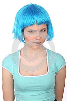 Girl in blue wig bitting her lip. Close up. White background