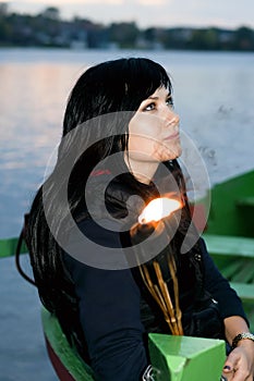 Girl in a boat ashore lake