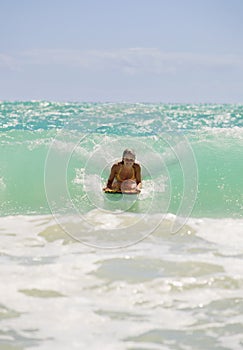 Girl boogie boarding the waves