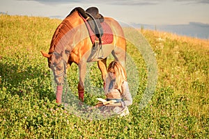 Girl with book in the field. woman walking with horse