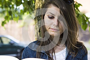 Girl with book in summer park