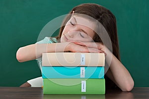 Girl With Books Sleeping At Desk