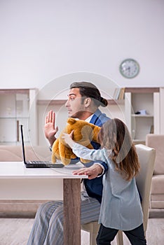 Girl bothering young father during working from house in pandemi