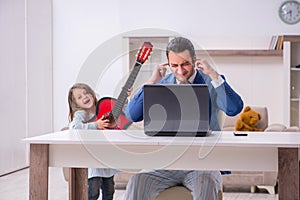 Girl bothering young father during working from house in pandemi