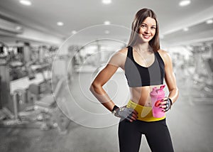 A girl with a bottle in the gym