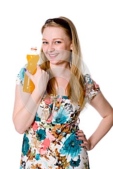 A girl with a bottle of orange juice