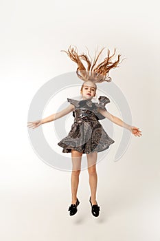 Girl bounces up on a white background photo