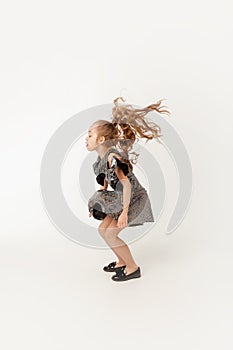 Girl bounces up on a white background photo