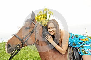 Girl with a bouquet of irises on a horse