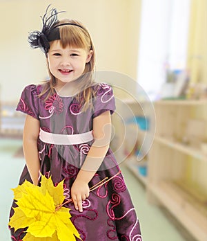 Girl with a bouquet of maple leaves