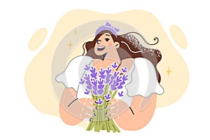 Girl with bouquet wild flowers enjoys aroma of bouquet collected in forest and wants to put in vase