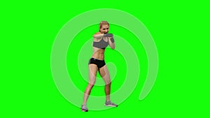 Girl boxer sends frequent blows to the enemy. Green screen