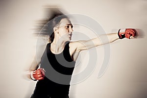 Girl with boxing gloves in motion
