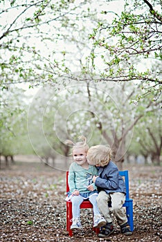 Girl, boy and almond blossom