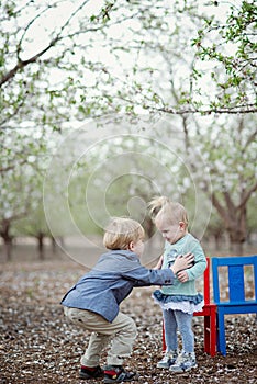 Girl, boy and almond blossom