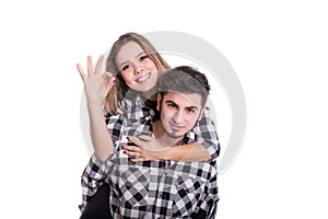 Girl on boy back showing ok sign isolated