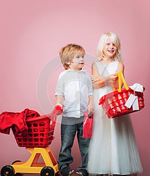 Girl and boy children shopping. Couple kids hold plastic shopping basket toy. Kids store. Mall shopping. Buy products
