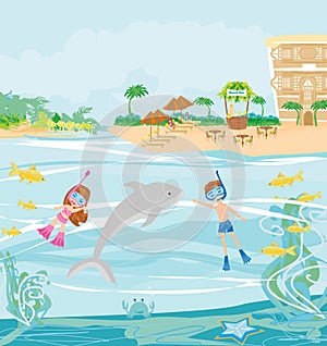 Girl and boy are diving with a dolphin