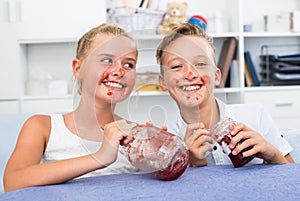 Girl and boy are eating jam