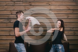 Girl and boy having pillow fight