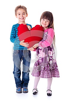 Girl and boy holding a big red heart shaped pillow