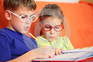 Girl and boy intently doing homework