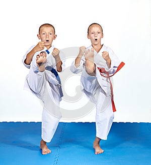 Girl and boy in karategi beats mae-geri photo