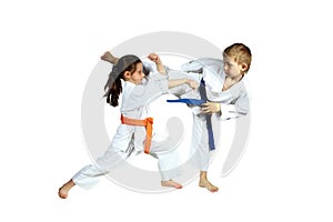 Girl and boy in karategi are training paired exercises karate