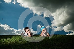 Girl and boy laying on the grass