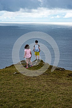 Girl and Boy looking out over Slieve League Cliffs, County Donegal, Ireland