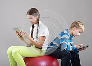 Girl and boy looking at Pad Tablet PC screens