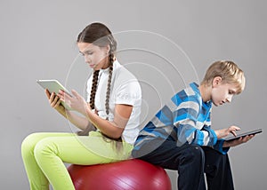 Girl and boy looking at Pad Tablet PC screens photo