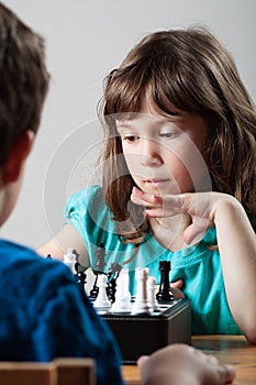 Girl and boy playing chess