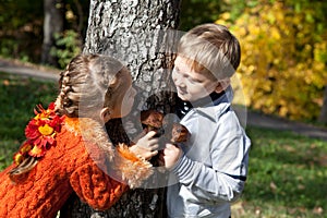 A girl and a boy are playing hide-and-seek photo