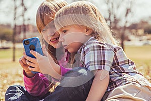 Girl and boy playing with phone