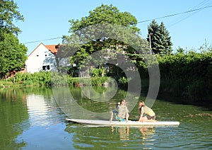 Girl and boy playing on surf