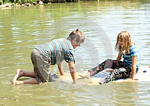 Girl and boy playing on surf